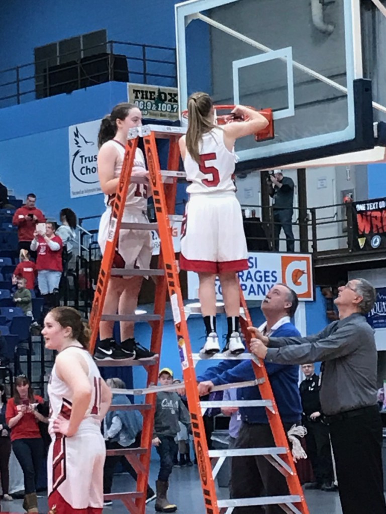 Vinalhaven captain Paige Dennison cuts down one of the nets at the Augusta Civic Center after the Vikings upended Rangeley 59-49 in the Class D South title game Saturday.