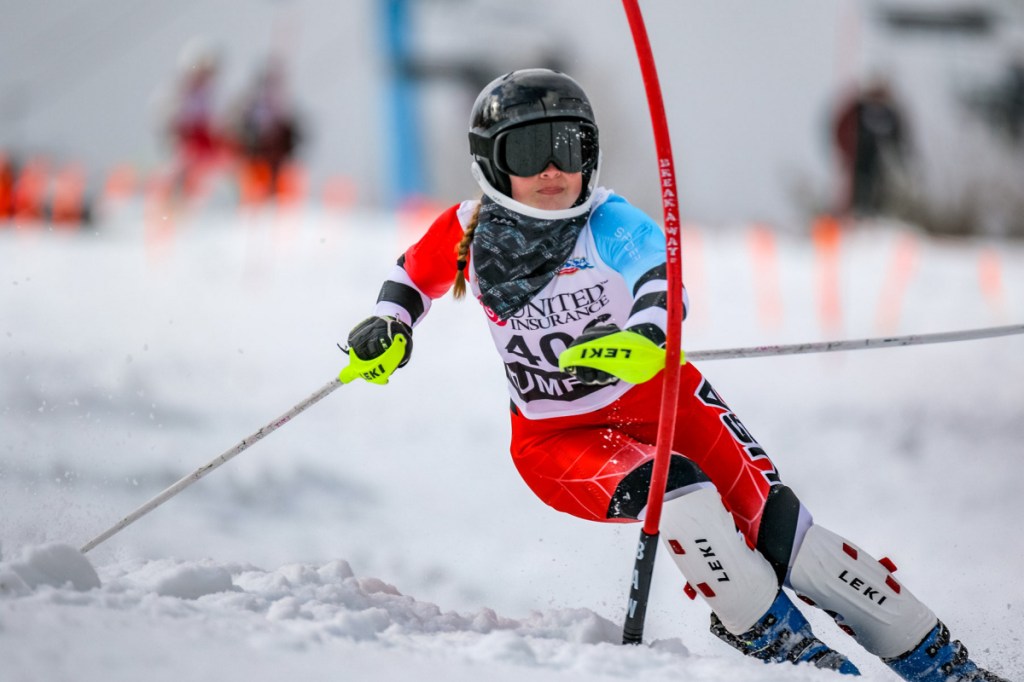 Edward Little's Jordan Cummings cross blocks a gate during her second run in the slalom event at the class A alpine championships at Black Mountain of Maine in Rumford. Cummings finished 14th helping her team come away with a second place finish overall.