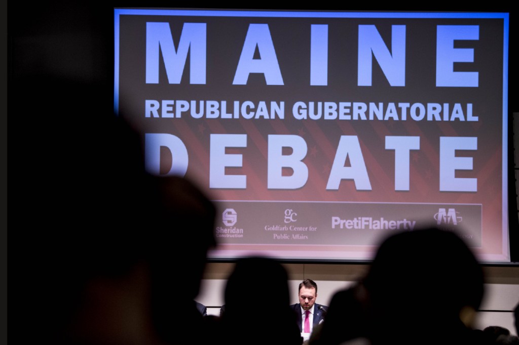 Garrett Mason, bottom center, one of five candidates participating in a debate gives his opening remarks at Ostrove Auditorium at the Diamond Building at Colby College in Waterville on Monday.