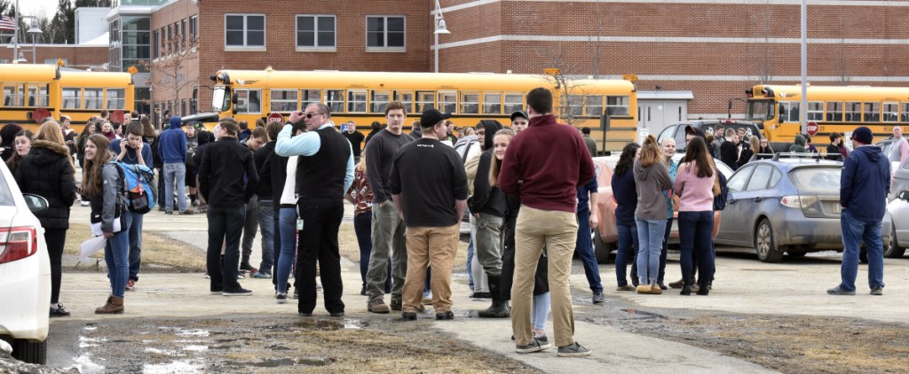 About 750 students, along with school staff, stand outside the Mount View school complex in Thorndike after being evacuated because of a suspected chemical release Wednesday. Apparently a student released pepper spray in a classroom, affecting about 20 students.