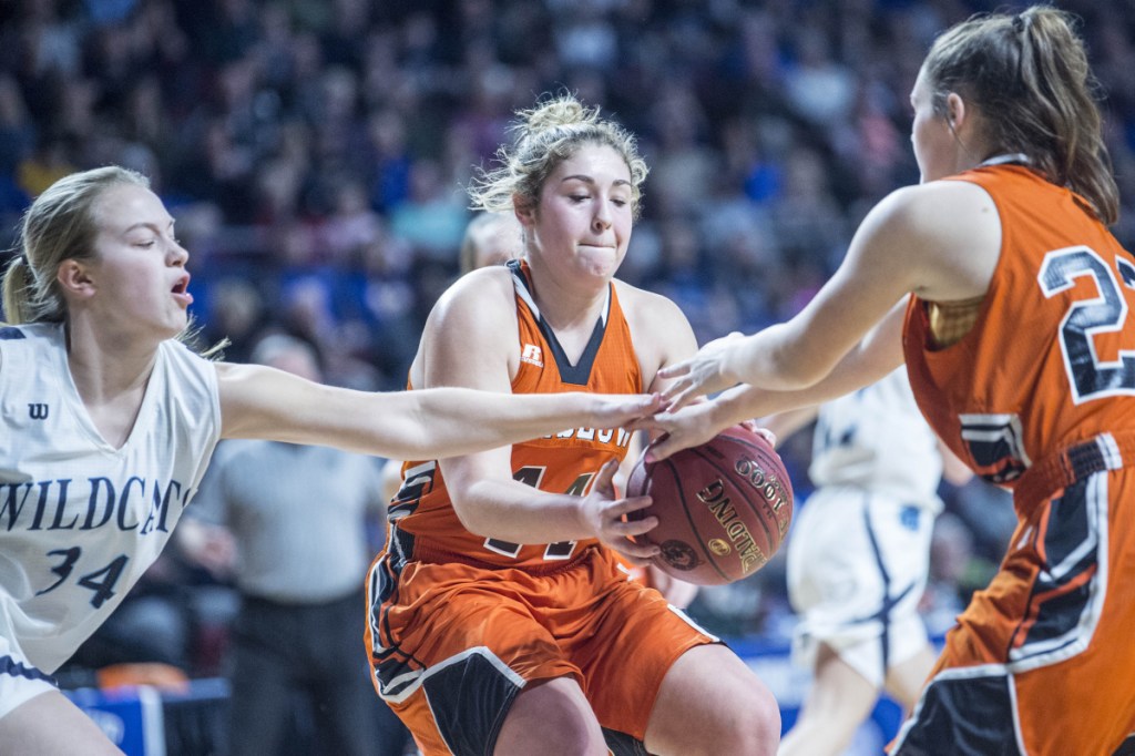 Winslow's Weslee Littlefield, middle, and Bodhi Littlefield battle for a rebound with Presque Isle's Sydney Thompson during the Class B North championship game Saturday at the Cross Insurance Center in Bangor.