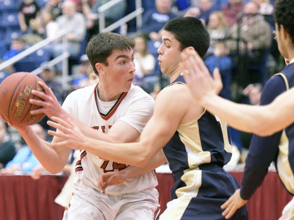 Hall-Dale's Owen Dupont, left, looks for an opening through Traip defenders during a Class C South quarterfinal game at the Augusta Civic Center.