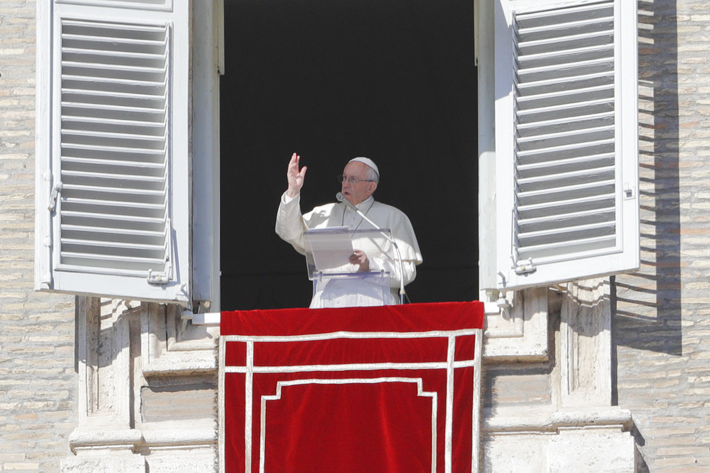 Pope Francis delivers a blessing from his studio's window overlooking St. Peter's Square on the occasion of the Angelus noon prayer at the Vatican, Sunday.