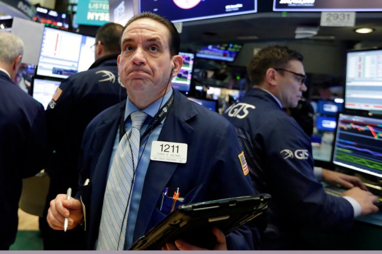 Trader Tommy Kalikas works on the floor of the New York Stock Exchange, Monday. Stock markets around the world took another pummeling Monday as investors continued to fret over rising U.S. bond yields.