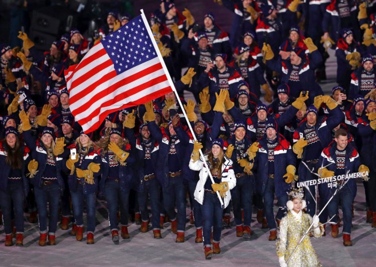 Erin Hamlin carries the flag of the United States during the opening ceremony of the 2018 Winter Olympics in Pyeongchang, South Korea, Friday.