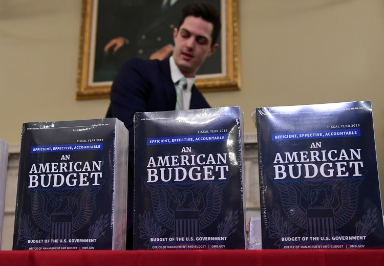 James Knable helps to unpack copies of the President's budget after its arrival at the House Budget Committee office in Washington on Monday.