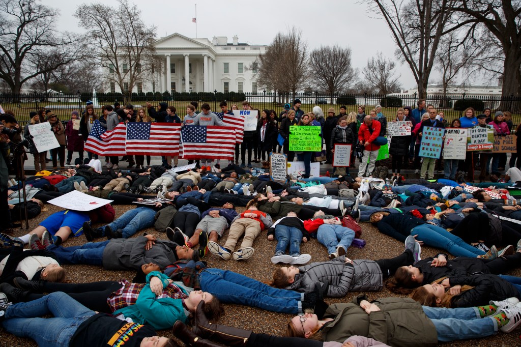 Demonstrators participate in a "lie-in" during a protest in favor of gun control reform in front of the White House, Monday, Feb. 19, 2018, in Washington. 