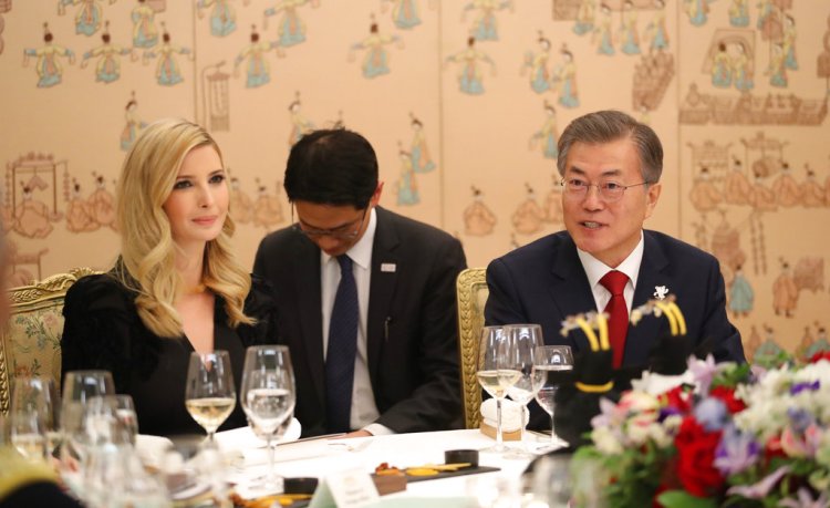 Ivanka Trump and South Korean President Moon Jae-in, right, have dinner at the presidential Blue House in Seoul on Friday. Trump is flanked by  Moon's aides who sat with heads bowed in gestures of respect. 