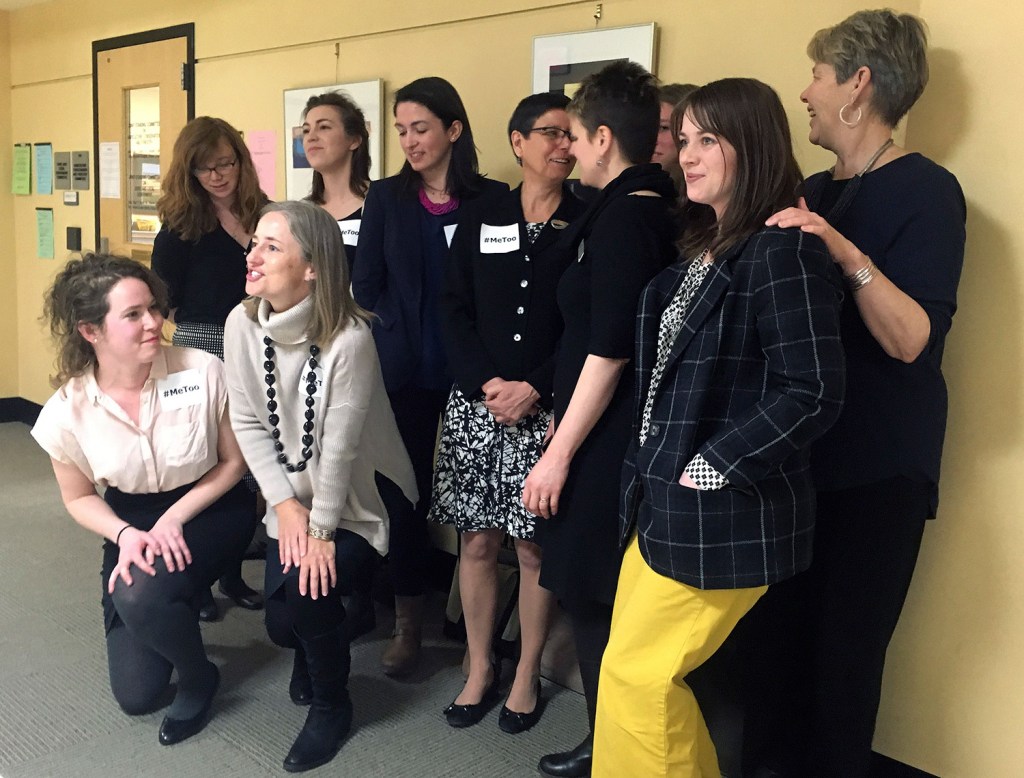 Lobbyists who testified Wednesday about their experiences of sexual harassment at the State House gather for a group photograph outside a committee room.