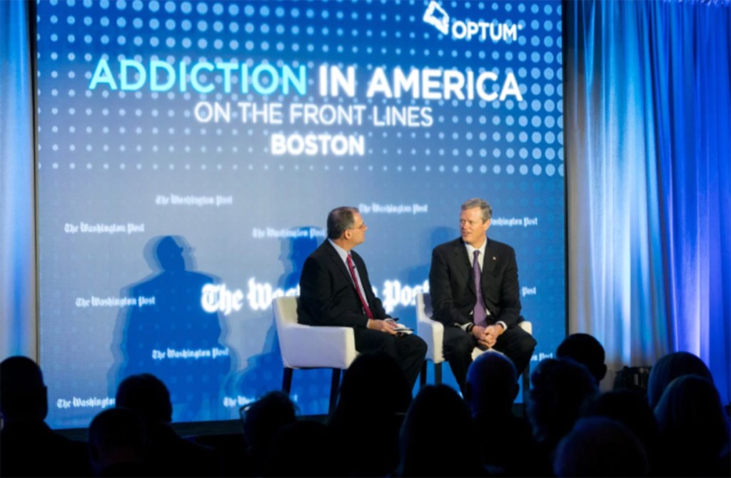 Massachusetts Gov. Charlie Baker, right, discusses the opioid crisis with Lenny Bernstein, a reporter for The Washington Post, on Thursday in Boston.