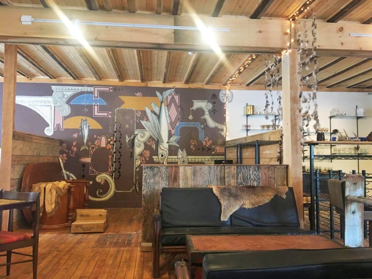 Much of Vessel and Vine's interior consists of items sourced by Iacono, such as tables from a Chinese restaurant in Lewiston and a mattress frame hanging from the ceiling. Iacono's friend Yennika Ekstrand painted the mural on the wall. 