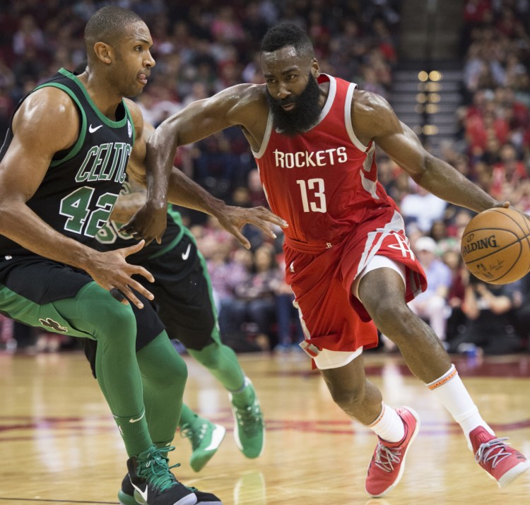 James Harden of the Houston Rockets attempts to drive past Al Horford of the Boston Celtics during Houston's 123-120 victory Saturday night. The Rockets have a 15-game winning streak.
