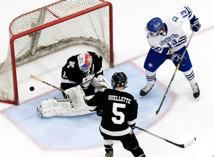 St. Dom's goalie Gaston Fuksa saves a shot by Caden Smith of Lewiston during the second period of the Class A North final Tuesday in Lewiston.
