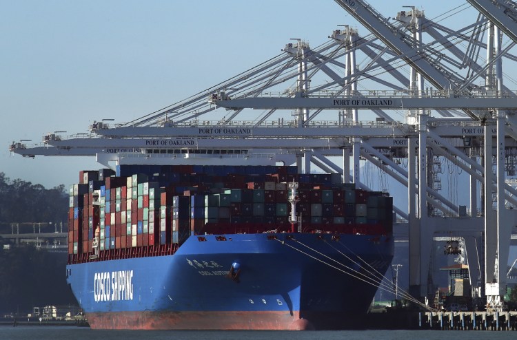 A container ship waits to be unloaded at the Port of Oakland in January.