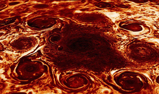 A composite image shows a cluster of cyclones found at the north pole of Jupiter.