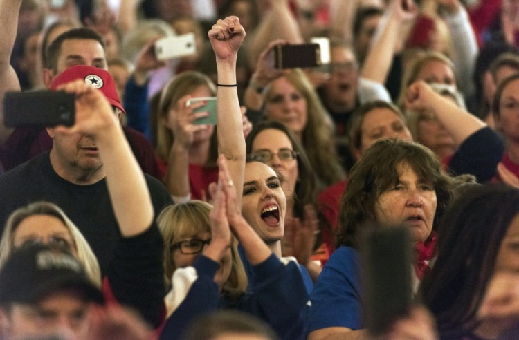 Teachers celebrate after the state Senate approved a bill to increase state employee pay by 5 percent at the capitol in Charleston, W.Va., on Tuesday.