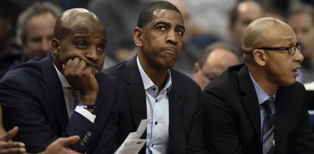 Connecticut Coach Kevin Ollie, center, is just two seasons removed from an American Athletic Conference title, but after leading his Huskies to a 14-17 record in the regular season, he could be on the hot seat.