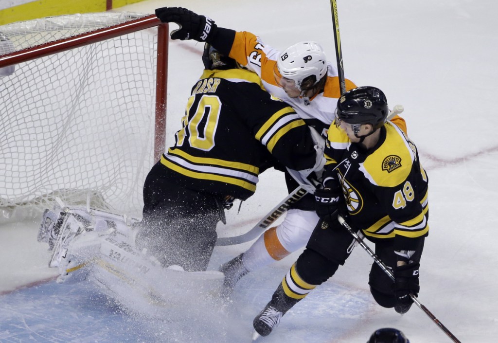 Philadelphia Flyers center Nolan Patrick crashes into Boston Bruins goaltender Tuukka Rask during Boston's 3-2 win Thursday night at TD Garden.
