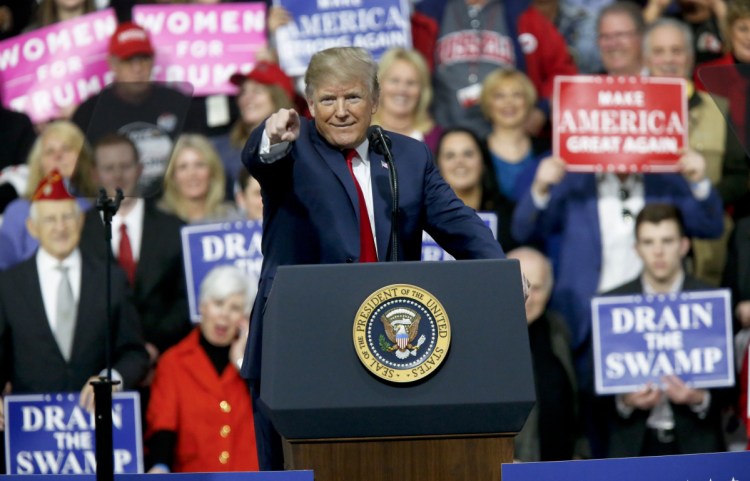President Trump reacts to the crowd while speaking at a campaign rally for Republican House candidate Rick Saccone in a hangar Saturday in Moon Township, Pa.