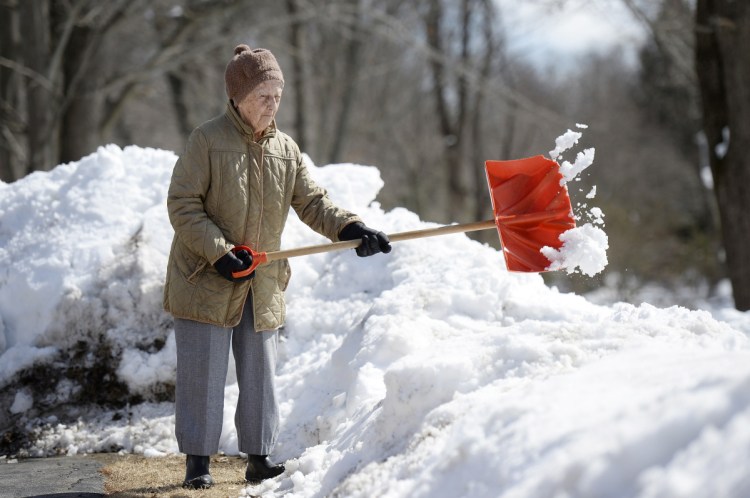 Eighty-eight-year-old Lorraine Vassill of Saco shovels snow away from her driveway Monday. "I'm making room for more," she said during a break between throws.