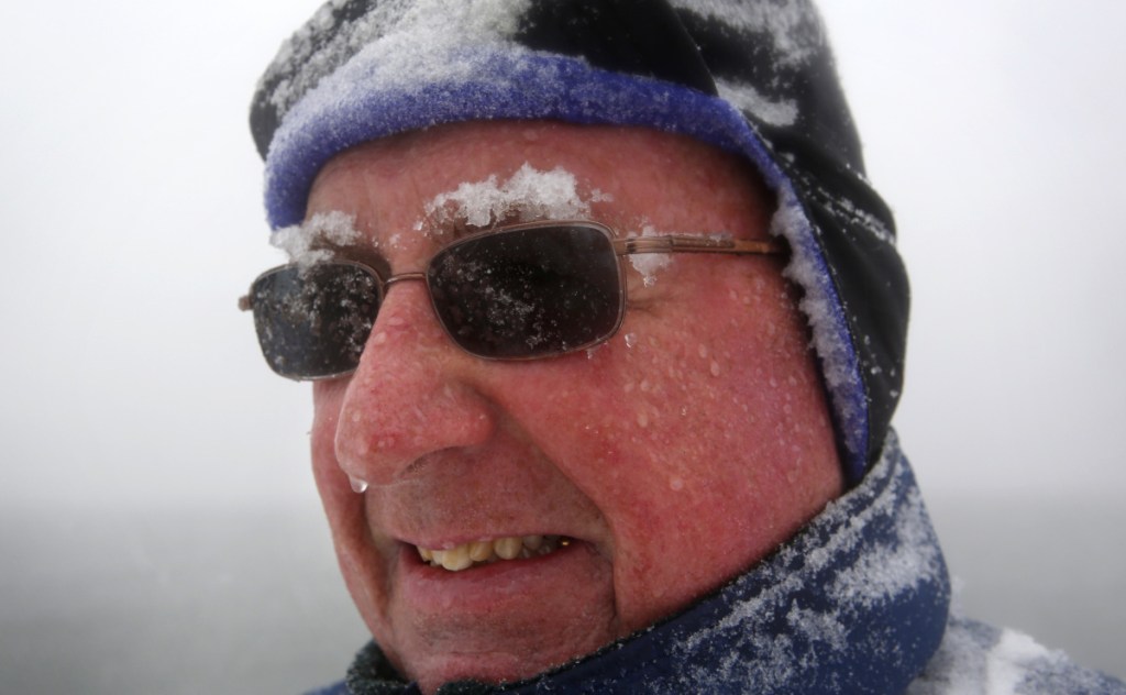 Snow accumulates on Paul Knight's eyebrows as he walks during a nor'easter, Tuesday, March, 13, 2018, in Portland, Maine. "It's typical March weather, we're not out of winter yet, that's for sure." he said. "The groundhog was right, six more weeks of winter and probably then some..." (AP Photo/Robert F. Bukaty)