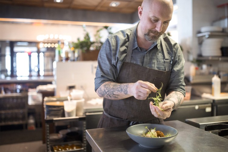 Chef Josh Berry garnishes toasted chickpea falafel with roast cauliflower at Union. The dish is vegetarian and gluten-free. "We experimented," Berry says of creating dishes while he's tried on various dietary restrictions. "There were a lot of epic failures, but some things worked out well."