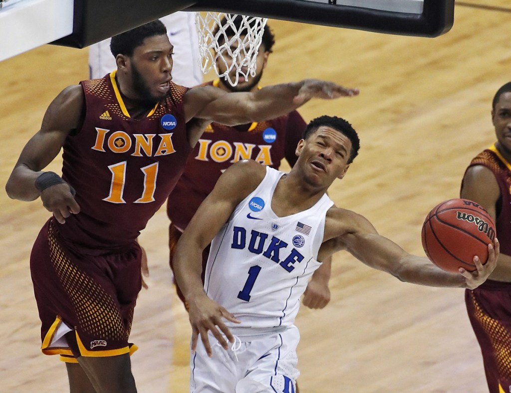 Duke's Trevon Duval gets off a shot with Iona's Roland Griffin defending during the second half of their game in Pittsburgh on Thursday. Second-seeded Duke advanced with an 89-67 victory.