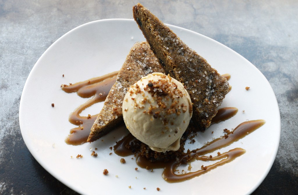 Hermit triangles are accompanied by a scoop of spiced rum ice cream.