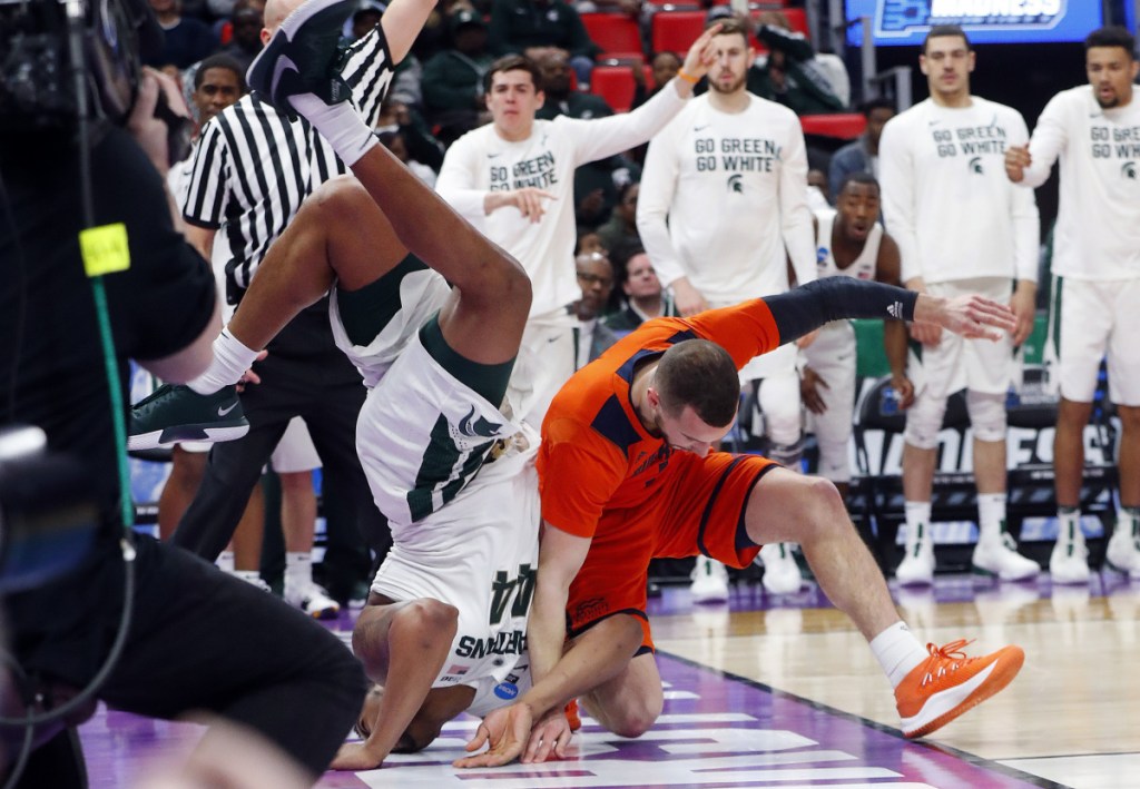 Nick Ward of Michigan State lands on his head Friday night after colliding with Kimbal Mackenzie of Bucknell during the second half of Michigan State's 82-78 victory at Detroit.