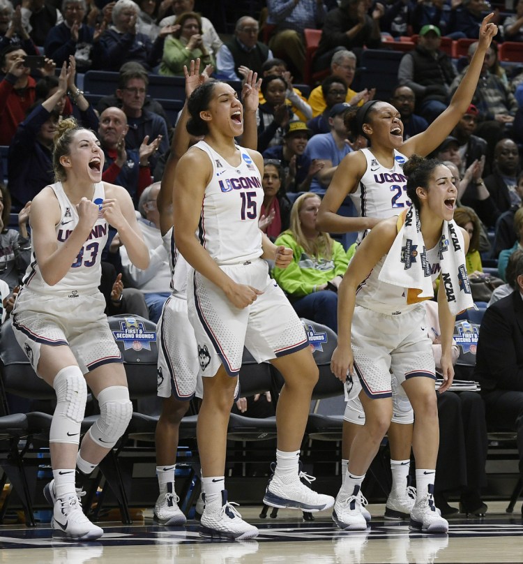 Connecticut's Katie Lou Samuelson (33), Gabby Williams (15), Kia Nurse (11), and Azurá Stevens (23) react on the sideline during the second half of a first-round game against Saint Francis (Pa.) in Storrs, Conn. on Saturday, March 17, 2018. UConn won 140-52.