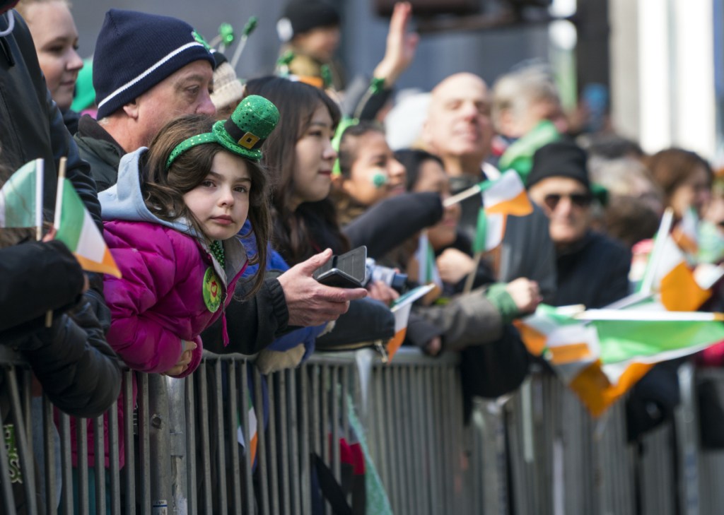 Spectators watch the St. Patrick's Day Parade pass by Saturday in New York. Associated Press/Craig Ruttle