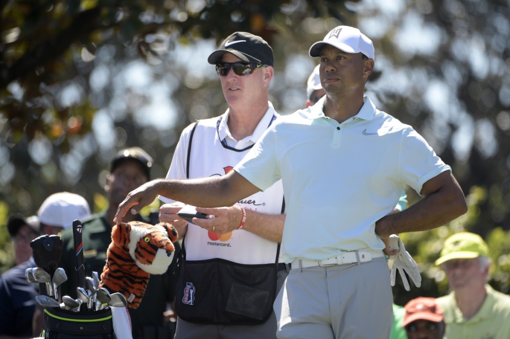 Tiger Woods, right, stayed in contention Saturday at the Arnold Palmer Invitational by shooting a 3-under 69, leaving him five shots behind Henrik Stenson.