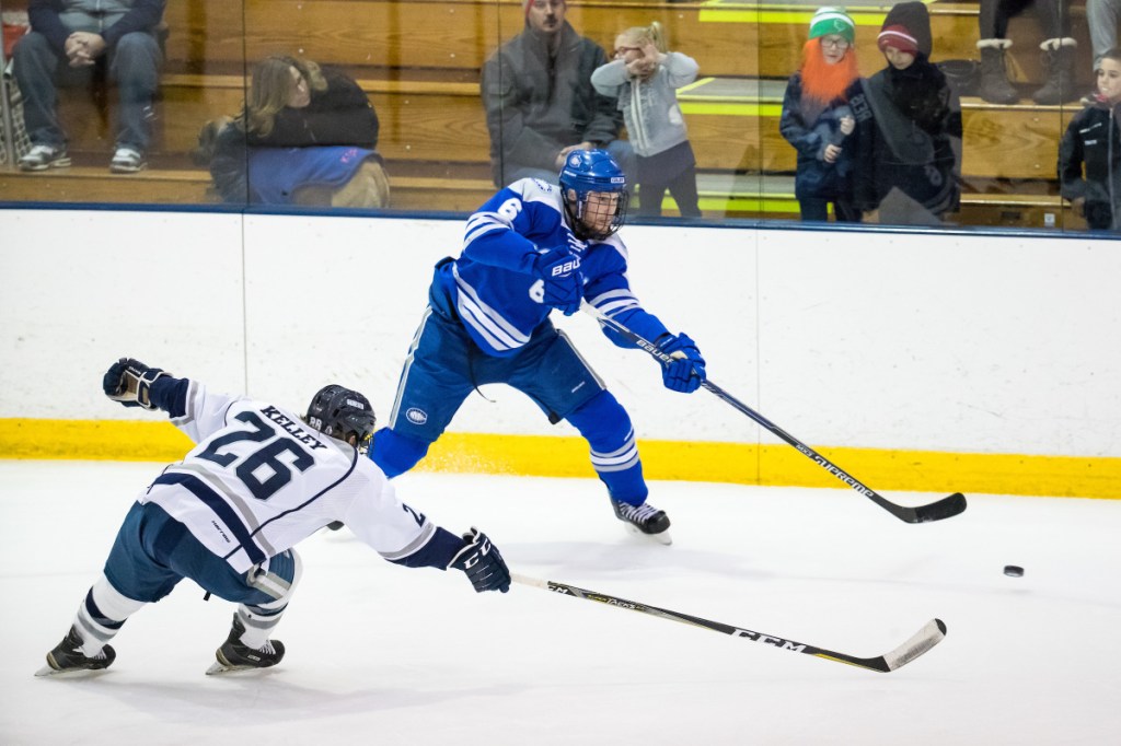 Andrew Reis of Colby makes a pass while defended by SUNY Geneseo's Carson Kelley during their NCAA Division III men's hockey quarterfinal Saturday night in Geneseo, N.Y. Colby got a goal in the closing seconds for a 2-1 win.