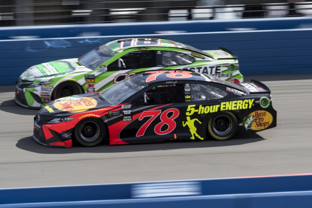 Martin Truex Jr., front, battles Kyle Busch for the lead with during Sunday's Cup Series race in Fontana, Calif. Truex took the lead from Busch with 32 laps remaining and went on to his first victory of the season.