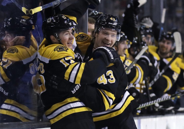 Bruins forward Ryan Donato, left, is congratulated by Danton Heinen after scoring in his NHL debut, a 5-4 OT loss to Columbus on Monday night.