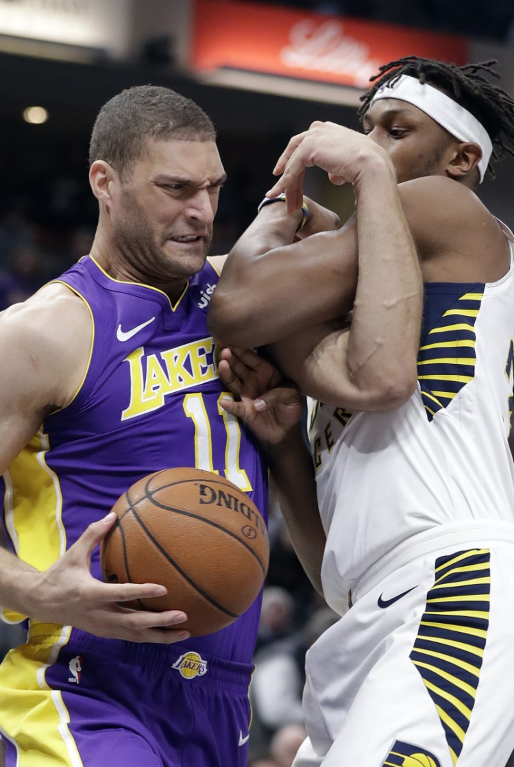 Brook Lopez of the Los Angeles Lakers goes to the basket against Myles Turner of the Indiana Pacers in the first half Monday night.