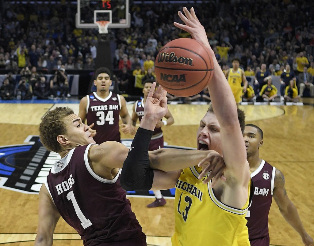 Texas A&M forward DJ Hogg, left, defends against Michigan forward Moritz Wagner in the first half of Thursday's regional semifinal in Los Angeles. The Wolvereines dominated to advance to the Elite Eight.