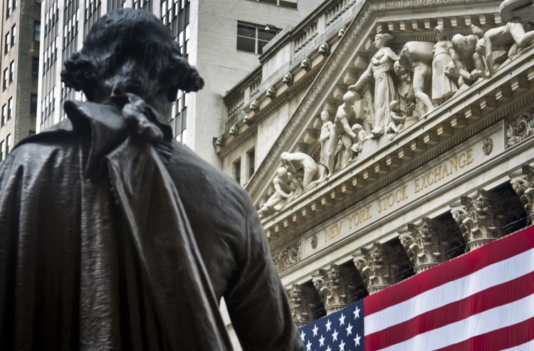 Federal Hall's George Washington statue stands near the flag-covered pillars of the New York Stock Exchange. 
