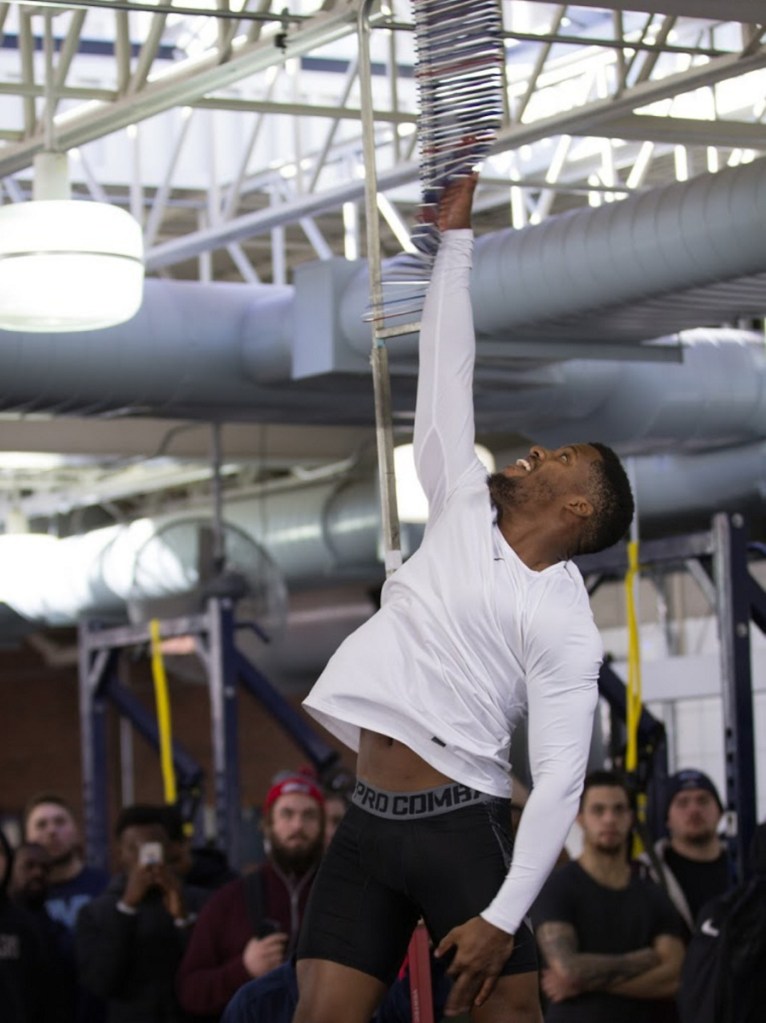 Cornerback Najee Goode, who has been training in Florida while preparing for UMaine's Pro Day, shows his talent in the vertical leap for the personnel from six NFL teams who traveled to Orono for the event Friday.