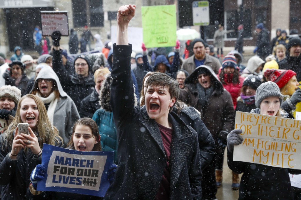 John Collins, 19, a University of Cincinnati student, cheers outside city hall during the "March for Our Lives" protest for gun legislation and school safety, Saturday, March 24, 2018, in Cincinnati. Students and activists across the country planned events Saturday in conjunction with a Washington march spearheaded by teens from Marjory Stoneman Douglas High School in Parkland, Fla., where over a dozen people were killed in February.
