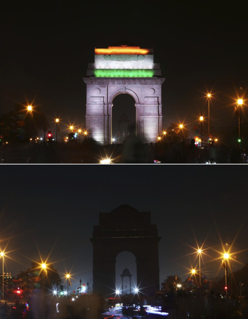 The landmark India Gate monument is shown lighted, top, and then in darkness when the lights were turned out for one hour to mark Earth Hour, in New Delhi, India, Saturday.