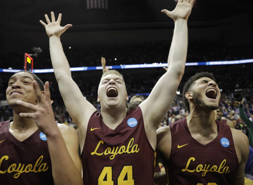 Loyola's Lucas Williamson, Nick Dinardi and Christian Negron, from left, celebrate Saturday night after earning a berth in the Final Four with a 78-62 victory against Kansas State.