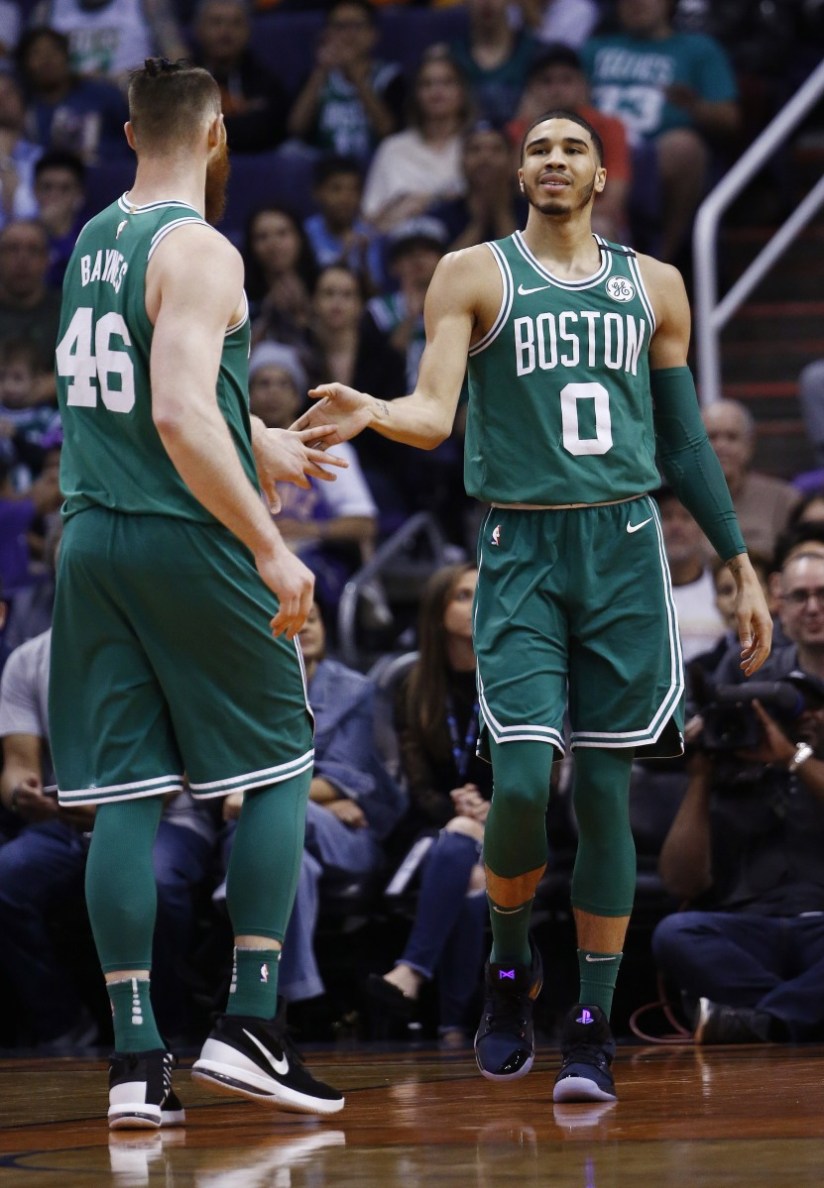 Celtics rookie Jayson Tatum, right, slaps hands with center Aron Baynes during the second half of Boston's 102-94 victory at Phoenix on Monday night. Tatum led Boston with 23 points. (AP Photo/Ross D. Franklin)