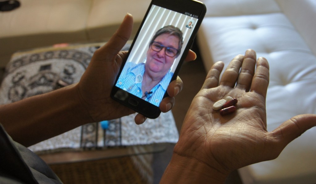 Public health nurse Peggy Cooley uses Skype video to remotely monitor a tuberculosis patient taking antibiotics at home in Lakewood, Wash.