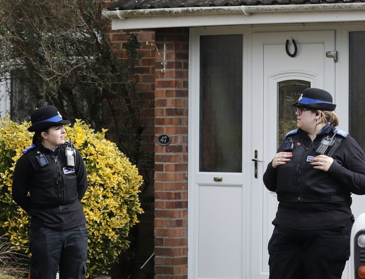 Police stand guard outside the home of former Russian spy Sergei Skripal.