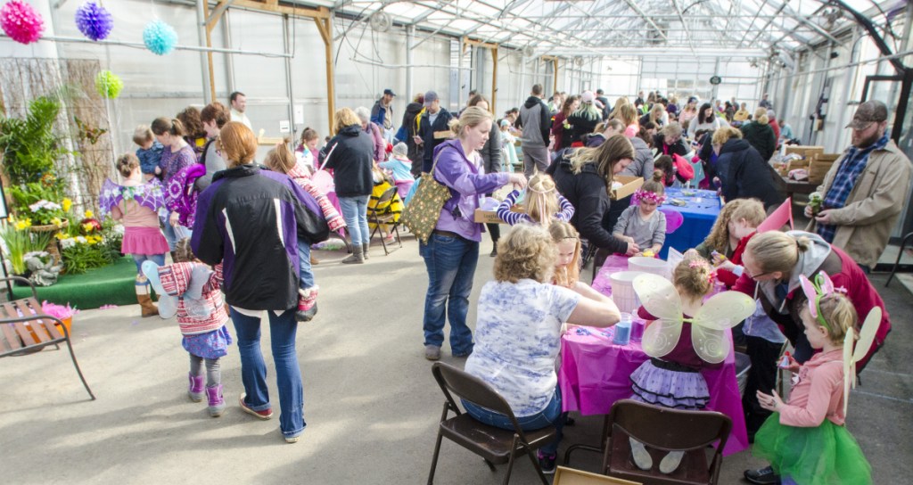 Adults help children make fairy arts-and-crafts projects Saturday during the Annual Fairy Festival at Longfellow's Greenhouses in Manchester.