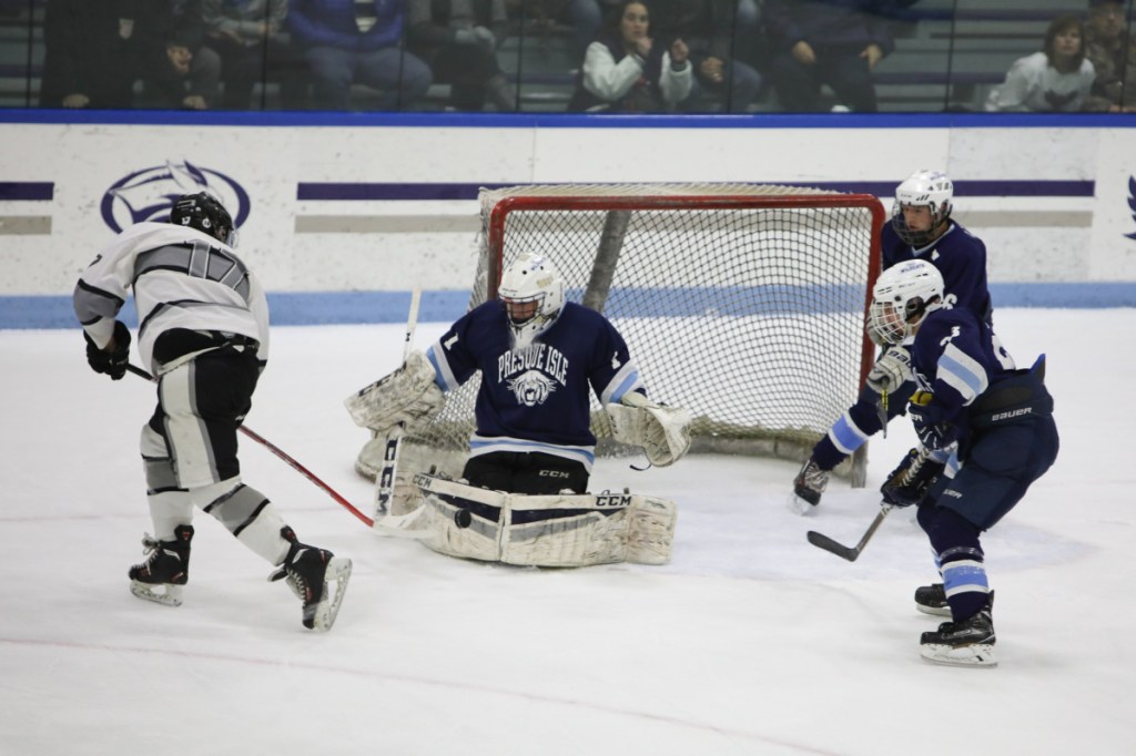 Kennebec's Cooper Hart (17) takes a shot on Presque Isle goalieAndre Daigle during a Class B North semifinal game Saturday at Colby College.