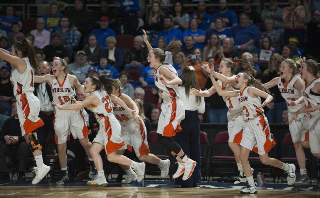 The Winslow girls basketball team celebrates after it beat Lake Region 43-29 in the Class B state championship game Friday night at the Cross Insurance Center in Bangor.