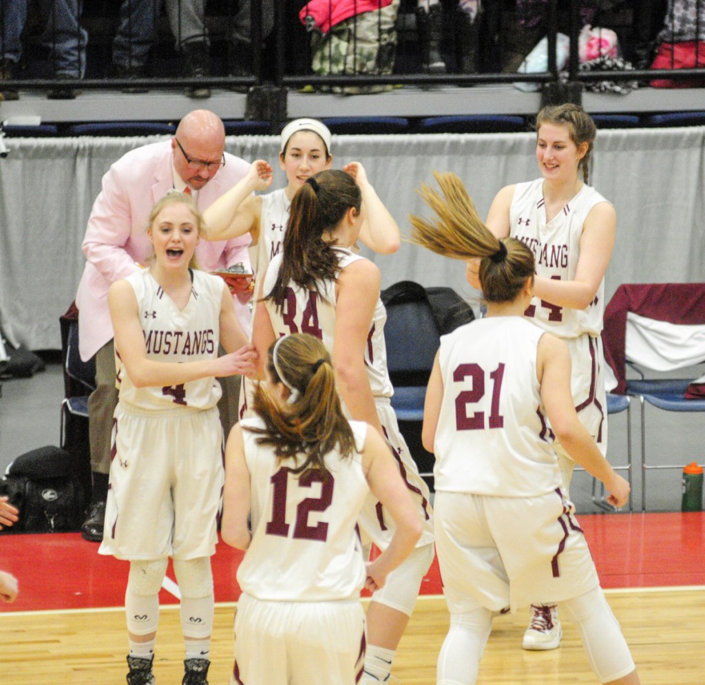 Staff photo by Joe Phelan
The Monmouth Academy bench celebrates after the Mustangs took off to an early lead against Houlton in the Class C state championship game Saturday at the Augusta Civic Center.