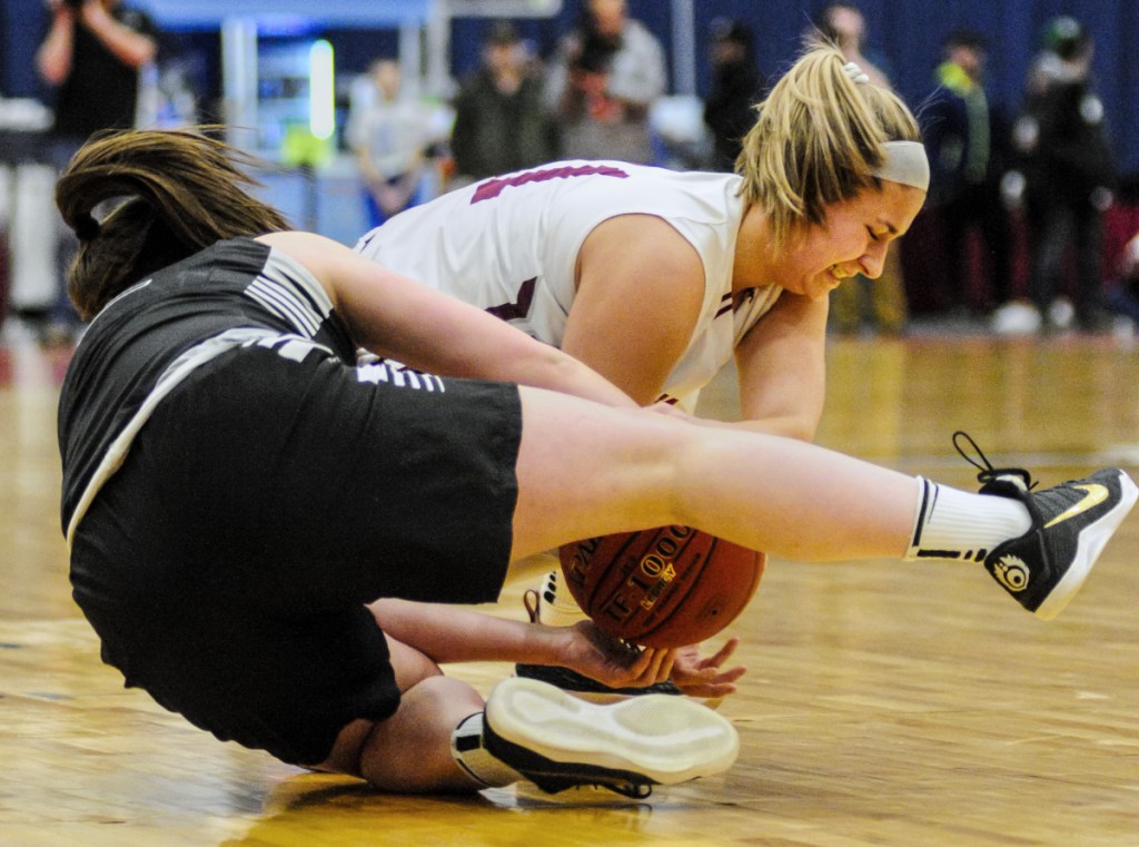 Staff photo by Joe Phelan
Houlton's Abbie Worthley, left, and Monmouth's Hannah Anderson wrestle for a loose ball in the Class C state championship game Saturday at the Augusta Civic Center.